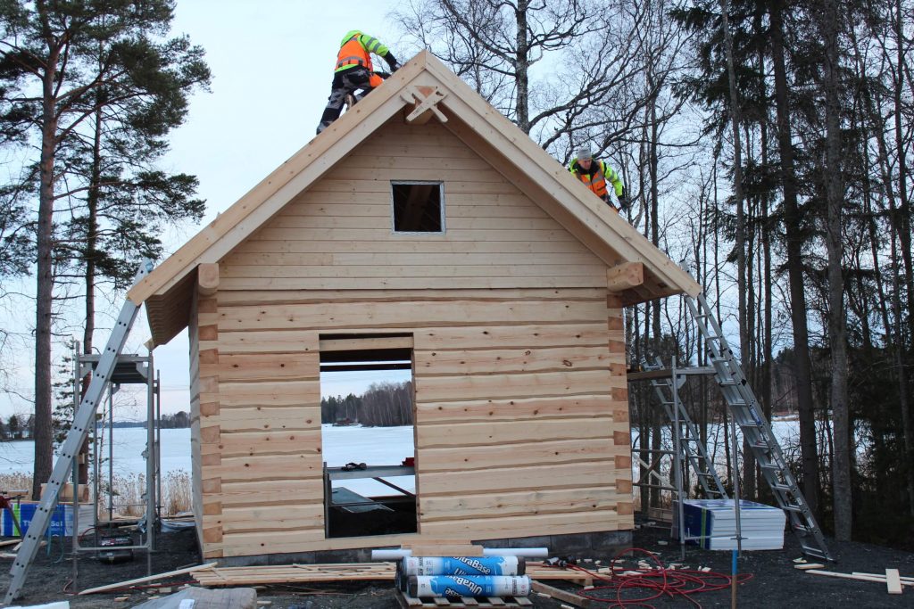 Log Sauna construction on the shore of the lake